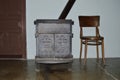 old wood stove and an old chair Royalty Free Stock Photo