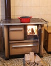 Old wood stove with fire in the kitchen of the small chalet Royalty Free Stock Photo