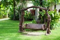 Old wood swing in the green garden
