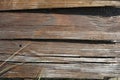 Construction wooden boards with old construction brown paint, green grass and sand after rain. Royalty Free Stock Photo