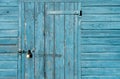 Old Wood texture Gate with Locked, Garage Door with Padlock, Rustic Blue Wooden wall with metal hinges,Barn entrance with sea blue Royalty Free Stock Photo