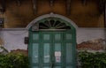 Old wood vintage door on the old broken wall with visible bricks texture was left to deteriorate over time, Western Architecture Royalty Free Stock Photo