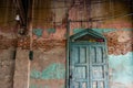 Old wood vintage door on the old wall with visible bricks texture was left to deteriorate over time Royalty Free Stock Photo