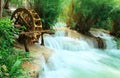 Old wood water turbine on waterfall at Tat Guangxi Waterfall, Luang Prabang.