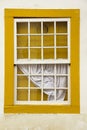 Old wood window painted yellow