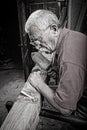 Old woodcarver working with mallet Royalty Free Stock Photo