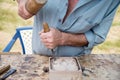 Old woodcarver working with mallet and chiesel Royalty Free Stock Photo