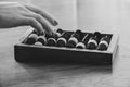 Old wooden abacus for counting money on a wooden table and a woman& x27;s hand counts on the abacus, black and white Royalty Free Stock Photo