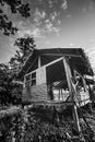 Old wooden abandoned cottage against sky