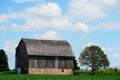 An old wooden abandoned farm barn sits on a farm field outside of Fond du Lac, Wisconsin. Royalty Free Stock Photo