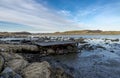 Old wooden abandoned pier on top of foundation of boulders on coastline of Hafrsfjord fjord in Tananger Royalty Free Stock Photo