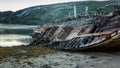 Old wooden abandoned ship stands on a sandy beach in beautiful n Royalty Free Stock Photo