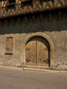 Old wooden arch door in Arreau, France. Royalty Free Stock Photo