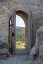 Old wooden arch in the fortress with open doors. Archway in stone wall. Rhodes Royalty Free Stock Photo