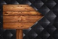 Old wooden arrows road sign on black background Royalty Free Stock Photo