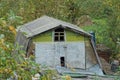 Old wooden attic of a barn with a small window under a gray slate roof Royalty Free Stock Photo