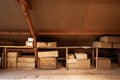 Old wooden attic interior with old cardboard boxes for storage or moving