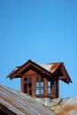 Old wooden attic window on metal roof Royalty Free Stock Photo