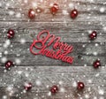 Old wooden background. With red balls, Merry Christmas text in the center, top view. Snow efect Royalty Free Stock Photo