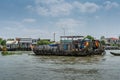 Old wooden barges on Kinh 28 canal in Cai Be, Mekong Delta, Vietnam