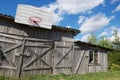 Old wooden barn with a basketball hoop attached.