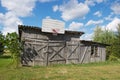 Old wooden barn with a basketball hoop attached.