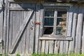 Old wooden barn with a closed door and broken window. Royalty Free Stock Photo