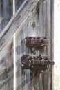 Old wooden barn door with rusty iron locking bars Royalty Free Stock Photo