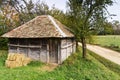 Old wooden barn by a gravel mountain road, Bobija mountain Royalty Free Stock Photo