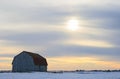 Old wooden barn in a snowy field Royalty Free Stock Photo