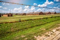 Old wooden barracks behind barbed wire, old prison Royalty Free Stock Photo