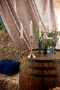 An old wooden barrel with floral decor.Photo zone for a photo shoot in the village style.