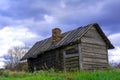 An old wooden bath house on the outskirts of the village. Against the background of the cloudy sky. Concept: old buildings, Royalty Free Stock Photo