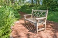 A old wooden bench in the beautiful botanical garden with sunlight shadow and shade in the day time.. Royalty Free Stock Photo