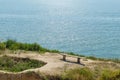 An old wooden bench on a cliff over the sea Royalty Free Stock Photo