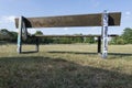 Old wooden bench overlooking soccer field with goal