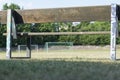 Old wooden bench overlooking soccer field with goal