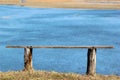 Old wooden bench on a river`s bank Royalty Free Stock Photo