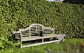 An old wooden bench and a watering-can Royalty Free Stock Photo