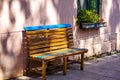 Old wooden benche and flowers in the street Royalty Free Stock Photo