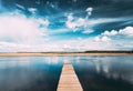 Old Wooden Boards Pier On Calm Water Of Lake Or River At Evening Or Morning Time. Forest On Other Side. Landscape Royalty Free Stock Photo