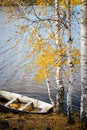 Old wooden boat in autumn Park, trees, fallen leaves and pond, autumn landscape Royalty Free Stock Photo