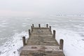 Old wooden boat dock on frozen lake Royalty Free Stock Photo