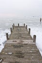 Old wooden boat dock on frozen lake Royalty Free Stock Photo