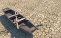 Old wooden boat on dry cracked soil. Dry river due to global warming. Climate change on Earth. Creative conceptual illustration