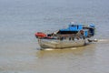 An old wooden boat float along the Soai Rap river shore