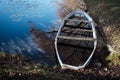 Old wooden boat full of water on pond Royalty Free Stock Photo