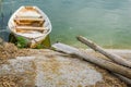 Old wooden boat greenish muddy river. Next to the old wooden oar. Local and rural landscape. Royalty Free Stock Photo
