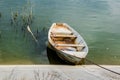 Old wooden boat greenish muddy river. Next to the old wooden oar. Local and rural landscape. Royalty Free Stock Photo