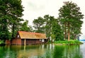 Old wooden boat house with thatched roof in an idyllic location on Lake Schwerin. Mecklenburg-Vorpommern Germany